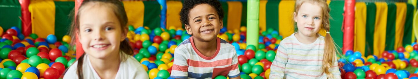 Three Cute Kids Playing in Ballpit