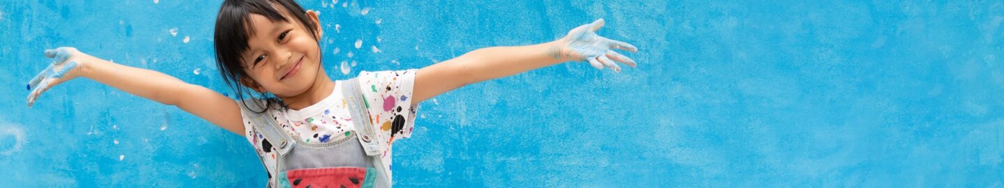 Banner of asian little girl is painting the blue color on the wa