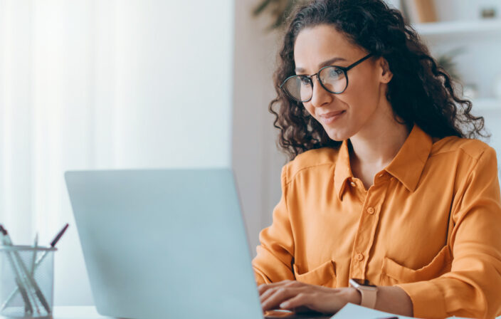 Middle Eastern Lady Using Laptop Working Online Sitting In Office